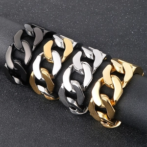 Close-up of chunky Cuban link rings in black, gold, and silver polished stainless steel