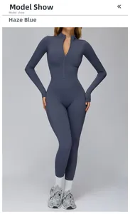 Detail of dusty blue yoga jumpsuit with half-zipper collar and thumbhole cuffs
