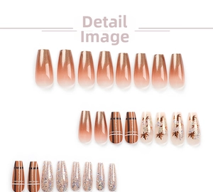 Macro detail of coffin shaped press-on nails with maple leaf glitter and brown gradient
