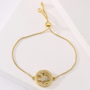 Adjustable gold leopard head charm bracelet with sparkling zircons and green stone eyes