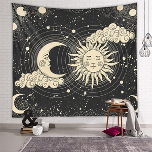 Detail of bohemian sun and moon tapestry hanging on a white brick wall in a cozy room
