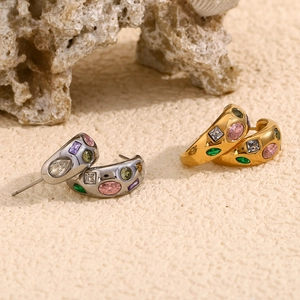 Detail of 18K gold and silver chunky C-shape earrings with colorful micro-set zircons