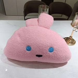 Close-up of pink rabbit plush pillow in soft sherpa fabric with cute button eyes