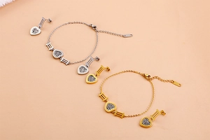 Detail of silver and gold heart jewelry set with Forever Love engraving and cubic zirconia