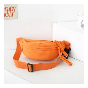 Detail of bright orange nylon kids fanny pack with durable strap and woven zipper puller