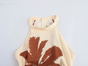 Detail of halter neckline with coconut tree print and back zipper on beige dress