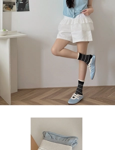 Close-up of striped cotton mid-calf socks featuring contrasting ribbed cuffs and knit texture