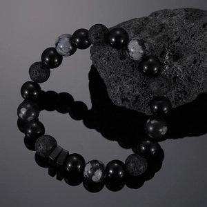 Detailed close-up of onyx, lava stone, and snowflake obsidian beads on a stylish bracelet
