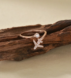 Macro detail of S925 sterling silver airplane ring with rose gold finish and pavé zircons