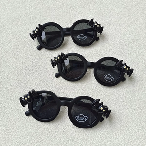 Three pairs of black bat-shaped kids sunglasses showing UV400 and CE certification labels