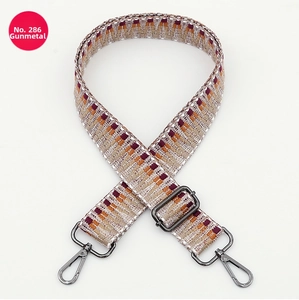 Detail of multi-color geometric ethnic strap with adjustable gunmetal buckle