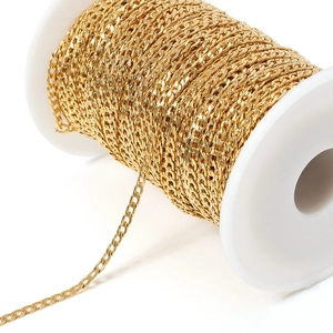Golden stainless steel Cuban link chain on a white spool for DIY jewelry making