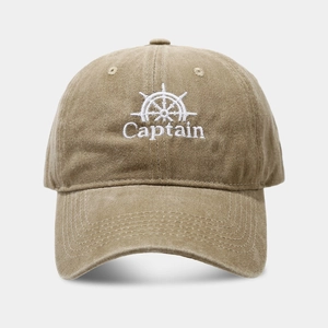 Close-up of white Captain embroidery and helm pattern on washed khaki baseball cap