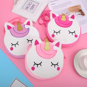 Detail of plush unicorn coin purse featuring glitter horn and embroidery decoration