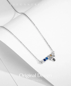 Detailed close-up of S925 silver honeycomb necklace with blue enamel and crystal bee