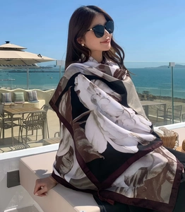 Ethnic printed sun protection shawl with floral pattern shown on a sunny beach balcony