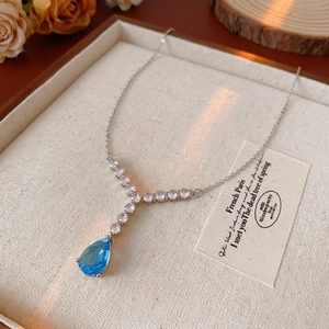 Elegant Y-shape silver necklace with a light blue pear zircon and white crystal pendant