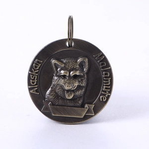 Detail of antique bronze pet ID tag with Alaskan Malamute relief and blank name area
