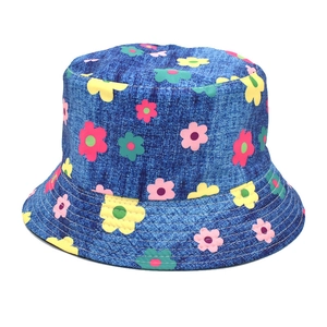 Detailed close-up of dark blue denim bucket hat with colorful floral patterns and embroidery