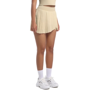 Side view of beige pleated tennis skirt with high elastic waistband and athletic fit