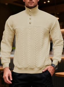 Detail of knit sweater stand collar with four metallic buttons and textured cable knit design