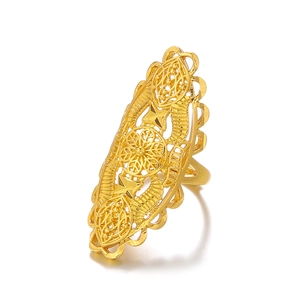 Dubai hollow gold plated ring with intricate ethnic flower patterns on white background