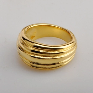 Macro shot of wide 18K gold plated titanium ring with unique textured ripple surface