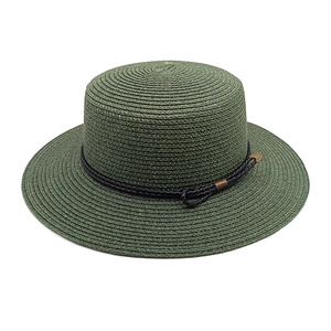 Macro shot of dark green boater hat with woven rope detail and bronze metal arrow accent