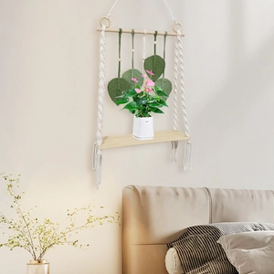 Bohemian macrame wall hanging shelf with green woven leaves and wooden display board