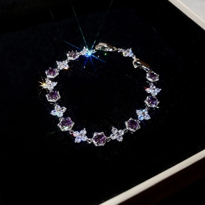 Elegant adjustable silver bracelet featuring purple floral crystals in a black gift box