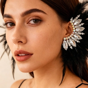 Detailed view of bohemian ear cuff featuring sparkling crystals and black fluffy feathers