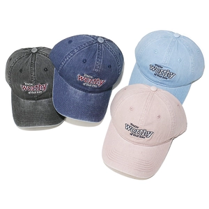 Detail of four washed cotton baseball caps with vintage embroidery in multiple colors