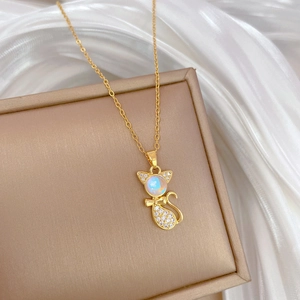 Golden titanium steel cat necklace with opal and zircon pendant on a silk background