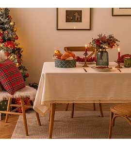 Detailed view of beige tablecloth with delicate lace borders in a festive dining setting