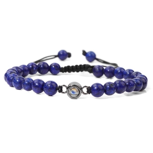 Close-up of deep blue stone beads bracelet with black woven cord and adjustable drawstring