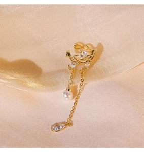 Detail view of gold-plated ear cuff featuring leaf design with pearl and crystal charms