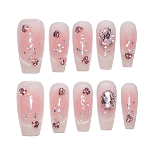 Pink gradient press-on nails with shiny rhinestones and silver glitter in coffin shape