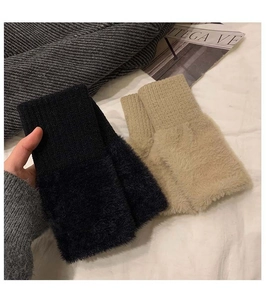 Detail of knit fingerless gloves with faux fur texture and ribbed wrist cuffs
