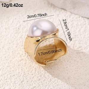 Detailed view of oversized 2cm faux pearl on a textured gold-plated adjustable ring
