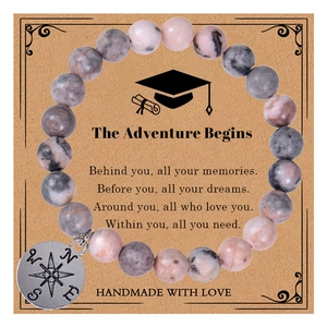 Detail of pink crystal beaded bracelet with compass charm on adventure gift card