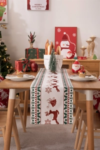 Close-up of modern Christmas table runner with festive deer and snowflake prints