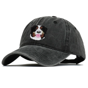 Close-up of Bernese Mountain Dog embroidery on a dark grey washed cotton baseball cap