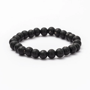 Close-up of black wooden beads with natural texture on a multilayer DIY fashion bracelet