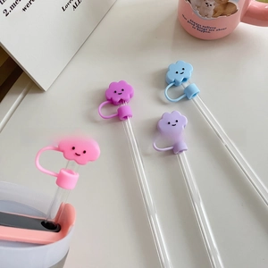 Close-up of smiley cloud straw covers in pink, purple and blue for cup accessories