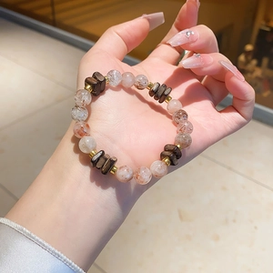 Detailed macro view of natural amethyst and citrine beaded bracelet with gold accents
