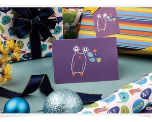 Detail of cartoon gift wrapping paper set with purple patterns, blue ribbons and cards
