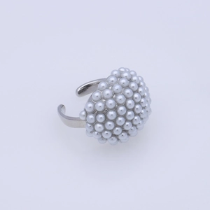 Detailed close-up of a silver open ring featuring a dense cluster of white faux pearls