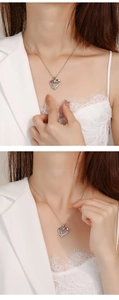 Detail of silver Mama heart necklace with sparkling rhinestones worn by a model