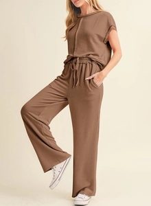 Detail of coffee brown ribbed lounge set showing fabric texture and elegant drape