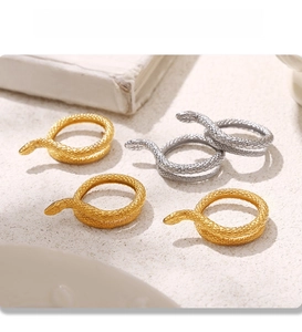 Detailed view of snake rings with PVD gold and silver finishes and textured scales